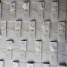 invitatie handmade personalizata cu coperta alba cu initialele mirilor pana sigiliu de ceara